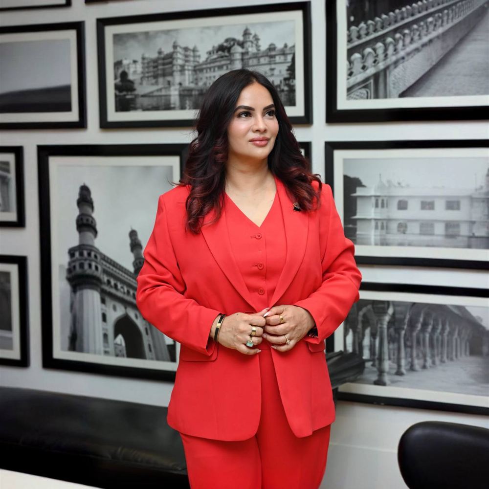 Roopali Talwar, mindset coach and speaker, in a red suit