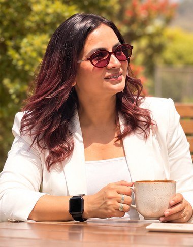Roopali Talwar, business owner and mindset coach, in a white blazer