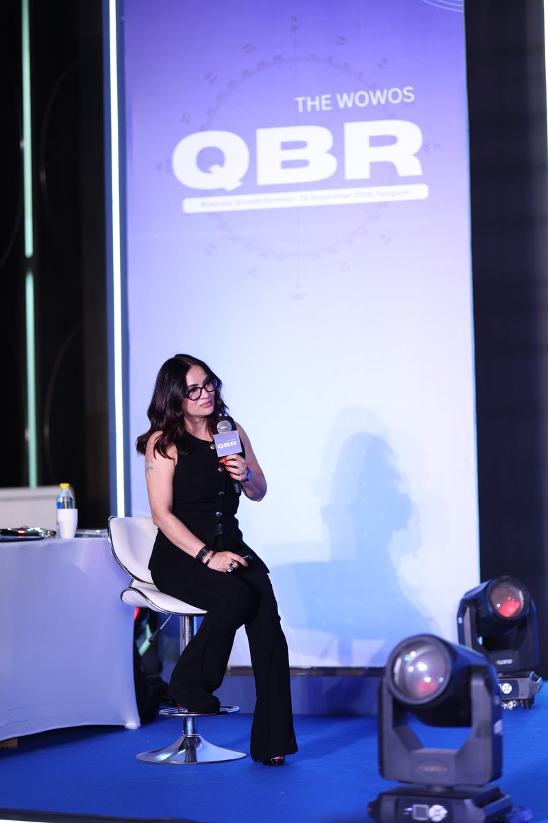Roopali Talwar speaking on stage at the WOWOS QBR